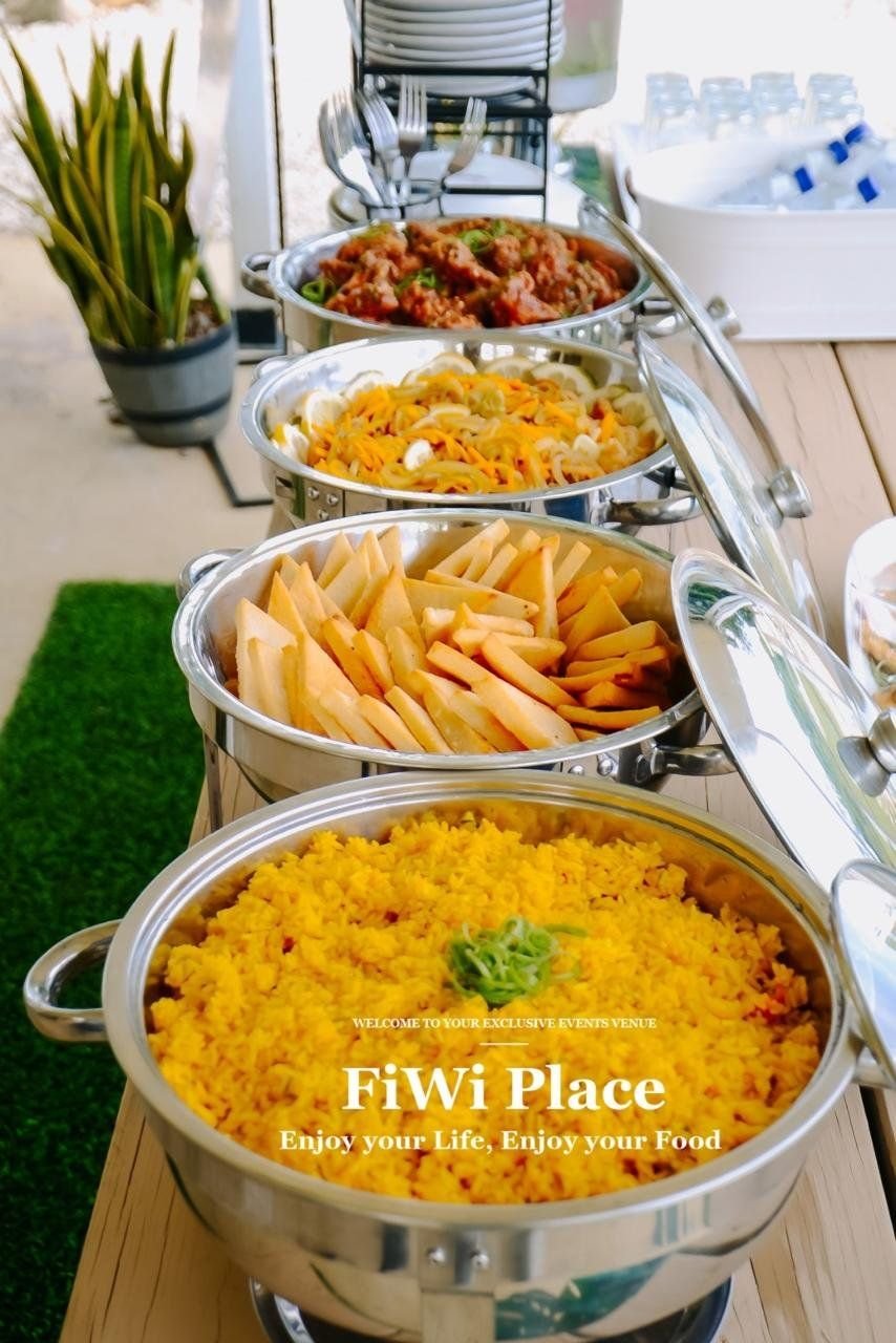 FiWi Place buffet with yellow rice, festival, pasta and jerk chicken in chafing dishes