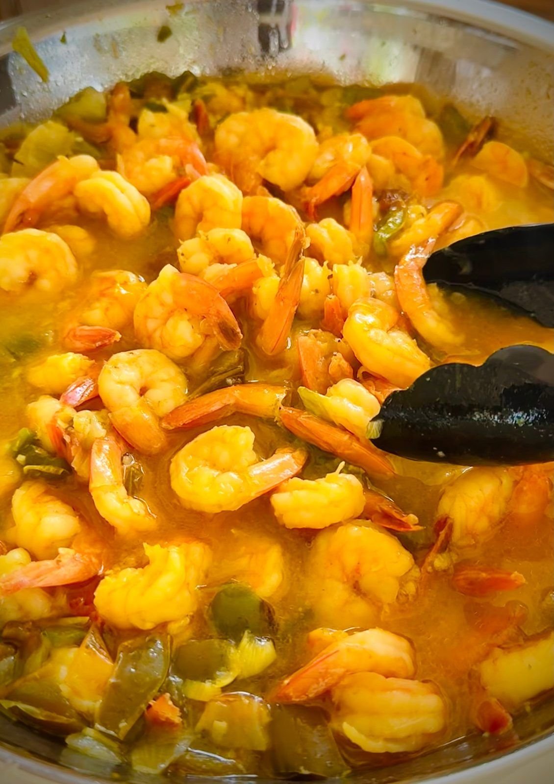 A pan of curried shrimp with peppers