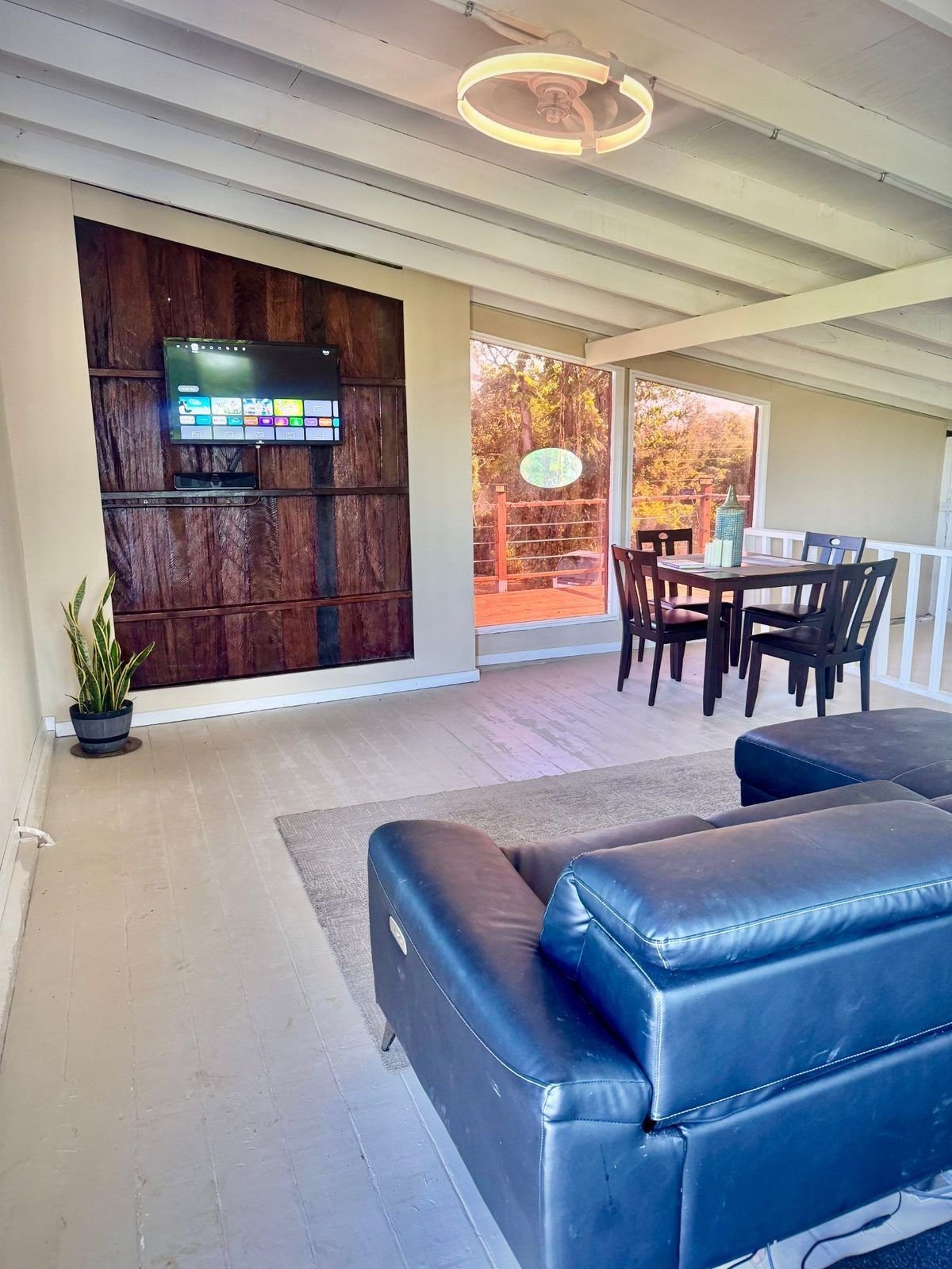 Indoor lounge with TV wall and dining set