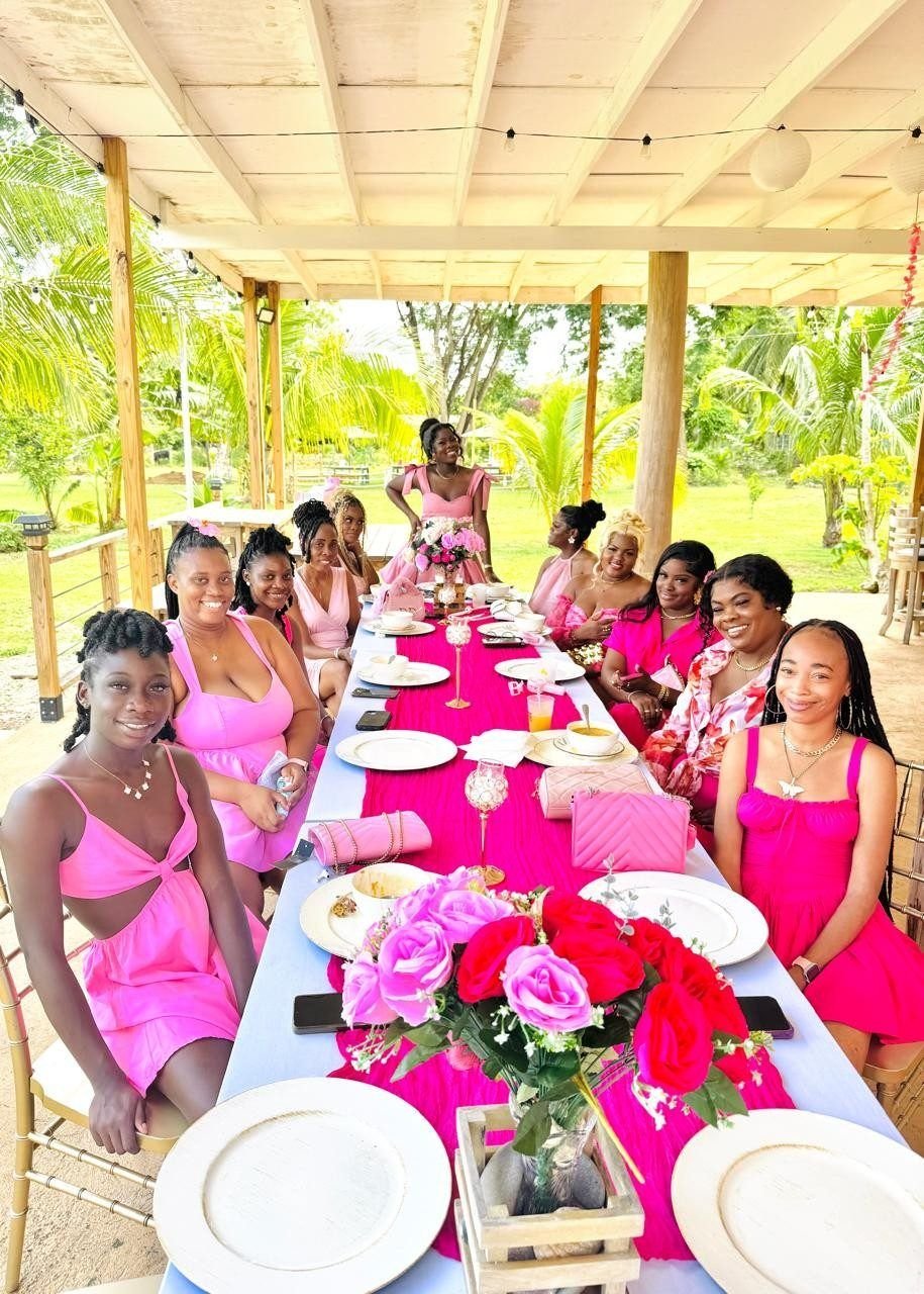 Guests in pink at a long brunch table